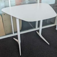 Table haute de marque EFE en bois stratifié blanc à plateau trapézoïdal reposant sur 2 pieds en acier laqué blanc. 71 x 140 x 110 cm. Localisation : 7 ouest – Image 2