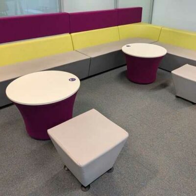 Espace d’attente de marque Connection en simili cuir vert et gris et feutrine violette, comprenant 4 banquettes, 2 tables et 2 poufs. 108 x 360 x 240 x 70 cm. Localisation : 6 est