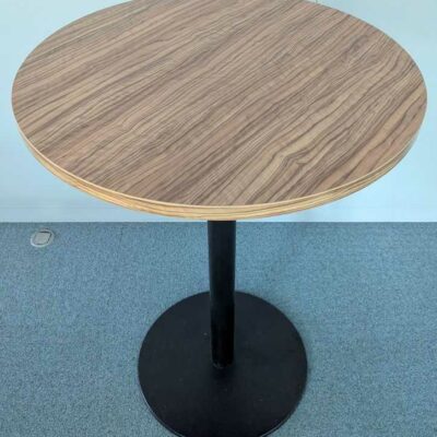 Mange debout, plateau rond en bois stratifié couleur noyer, pied colonne en acier laqué noir. 115 x 80 cm. 2 unités. Vendu à l’unité avec faculté de réunion. Localisation : 1 ouest, 1 est