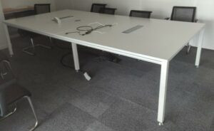 Table de réunion en 2 parties, plateau en bois stratifié blanc avec trappes techniques reposant sur 6 pieds en acier laqué blanc. 73 x 320 x 160 cm. Localisation : 8 av. de Lunca - 78180 Montigny-le-Bretonneux. (5 F02-2)