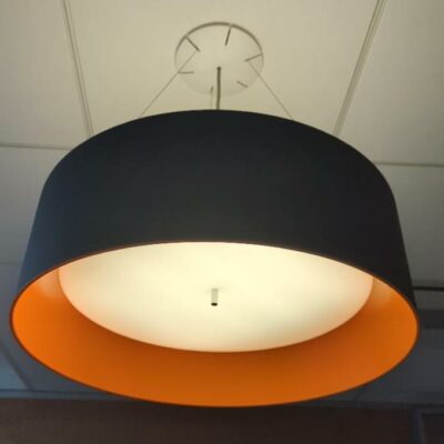 Suspension lumineuse ronde bicolore, abat-jour en plastique noir et orange avec diffuseur opaque, suspendu par trois filins. 17 unités. Vendu à l’unité avec faculté de réunion. Localisation : 6 rue Duret – 75116 Paris : rdc, rdc haut