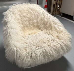 Fauteuil design de l'architecte Carlo Colombo modèle Katrin édition Arflex recouvert de fourrure type laine de mouton à long poil. Usures. 2 unités venues avec faculté de réunion.