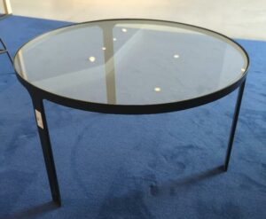 Table basse ronde tripode, structure en métal noir, plateau en verre transparent. 40 x 70 cm. (RDC bat A)