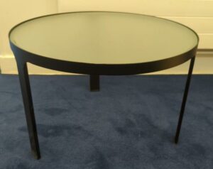 Table basse ronde tripode, structure en métal noir, plateau en verre opaque. 32 x 50 cm. (RDC bat A)