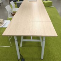 Table rectangulaire ajustable en hauteur de marque Buronomic, plateau couleur hêtre sur un piètement en acier laqué blanc avec entretoise. 105 x 300 x 100 cm. (1er bat A) – Image 2